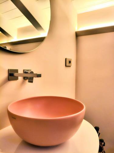 a bathroom with a bowl sink and a mirror at Casa dei Bruschi in Casarza Ligure
