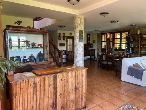 a living room with a wooden counter in a house at Hotel Rural Alavera in San Martin del Mar