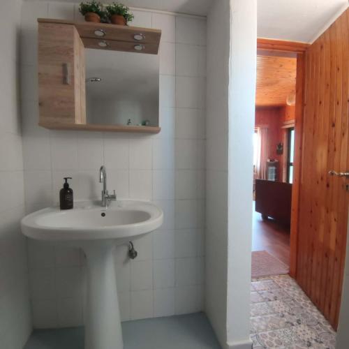 a bathroom with a sink and a mirror at Rising Sun Guesthouse in Mesokhória