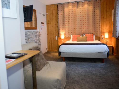 a hotel room with two beds and a desk at Les Campanules in Les Houches