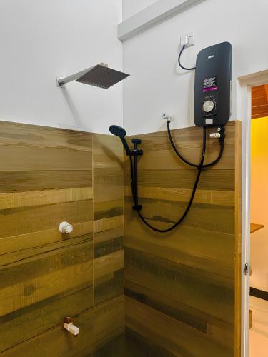 a shower in a room with wood paneling at Oak Haven Cabana Sigiriya in Sigiriya