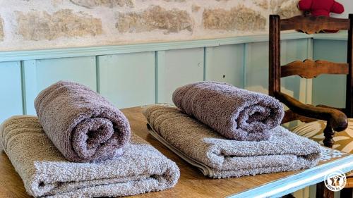 a pile of towels sitting on top of a table at Le Brocangîte à Jules - 4 pers in Bèze