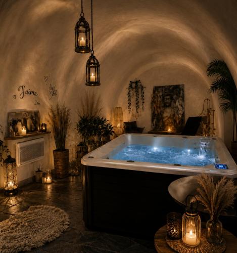 a bath tub in a room with lights and candles at Chambre d'Hôtes La Marlotte in Castello-di-Rostino