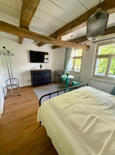 a bedroom with a bed and a flat screen tv at Im Dörnchen in Mettmann
