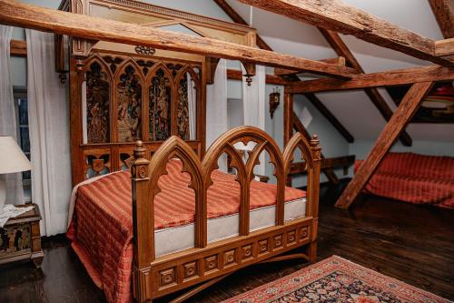 a bedroom with a wooden bed with orange sheets at Piena māja in Kukšas