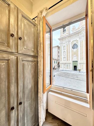 a window in a room with a view of a building at Casa Ferro in Finale Ligure