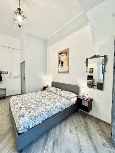 a bedroom with a bed and a mirror at Casa Ferro in Finale Ligure