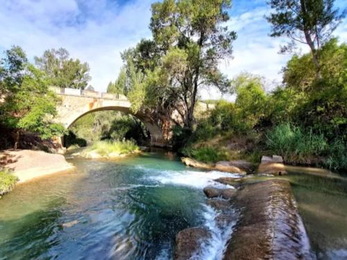 a bridge over a river with a river at Algarra Alojamientos in Algarra