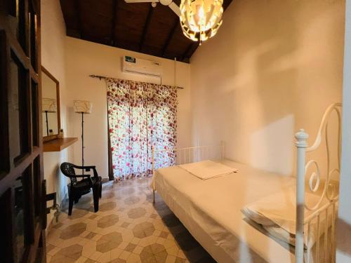 a bedroom with a bed and a window with a curtain at Amantha Holiday Resort in Anuradhapura