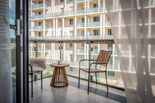 a balcony with a table and chairs and a building at Amada Apartment in Budapest