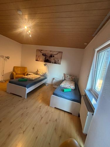 a room with two beds and a couch in it at Ferienwohnung Habichtweg in Elsdorf