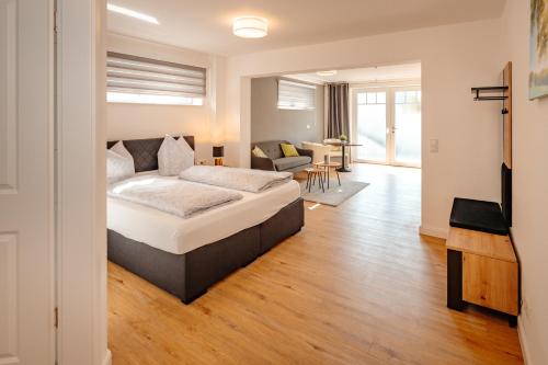 a bedroom with a bed and a living room at Ferienwohnung Riethchaussee in Wingerode