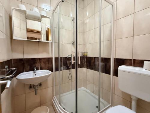 a bathroom with a shower and a sink and a toilet at Apartments Tomislav in Vodice