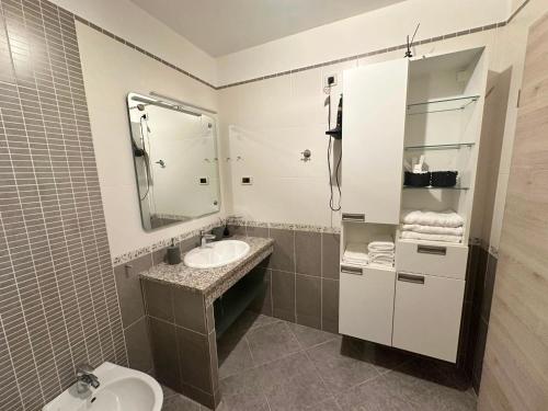 a bathroom with a sink and a mirror at Maver apartment in Mali Lošinj