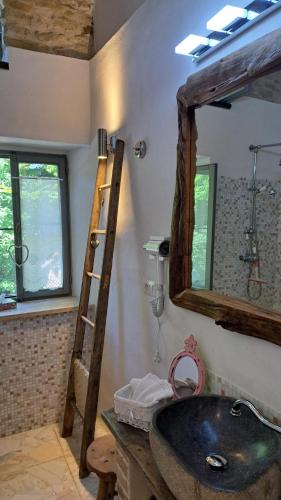 a bathroom with a large mirror and a sink at La Vita è Bella in Somano