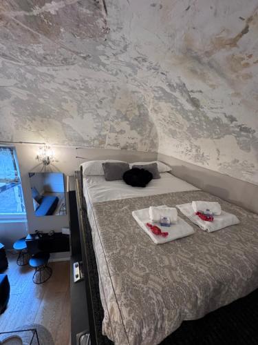 a bedroom with a bed with two towels on it at Via Corradi in Sanremo