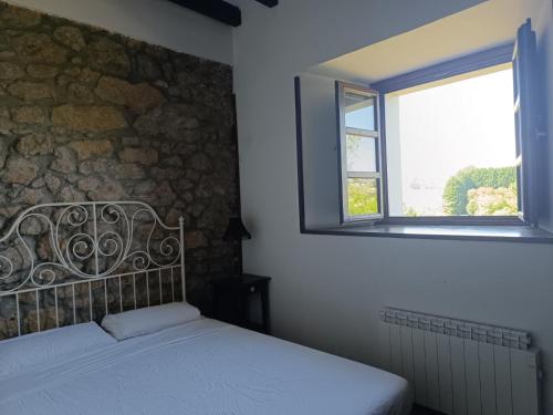 a bedroom with a bed and a window at El Rincon de Belen in Noriega