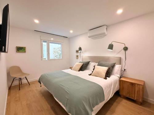 a bedroom with a large bed and a window at YourHouse O Rexo in Allariz