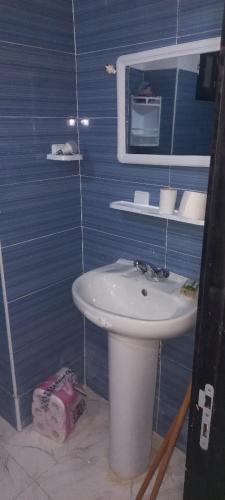 a bathroom with a white sink and a mirror at fenêtre de la mère in Al Hoceïma
