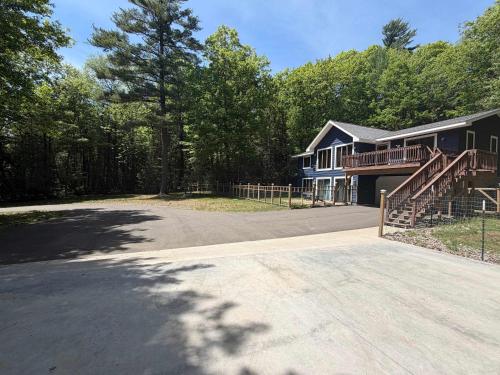 a large house with a porch and a driveway at Big St Germain Hideaway in Sayner