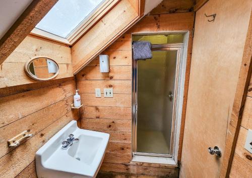 a bathroom with a sink and a mirror and a window at Oma's House in Warren