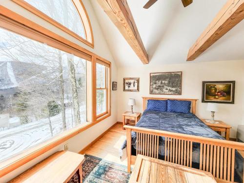 a bedroom with a bed and a large window at Oma's House in Warren