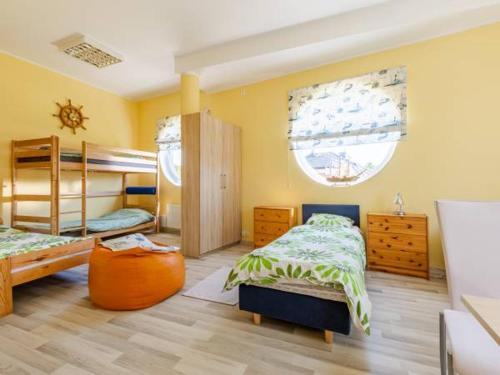 a bedroom with two bunk beds and a large window at Pokoje Gosia in Puck