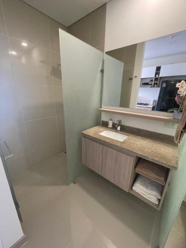 a bathroom with a sink and a mirror at Exclusive Rodadero Sur Studio Apartment in Santa Marta