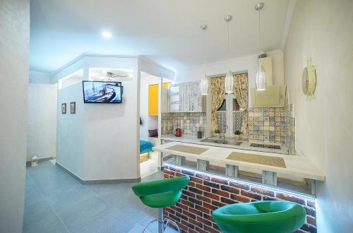 a bathroom with a sink and two green stools at Apartment at Lyulki in Lviv
