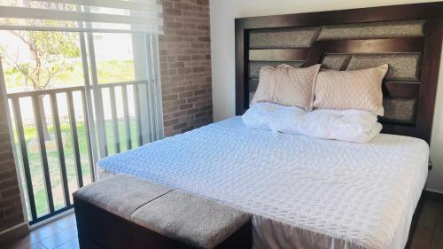 a bedroom with a bed with a large window at Torre 23 in Oaxaca City