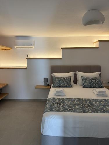 a bedroom with a large white bed with pillows at Podotas Group in Kamares