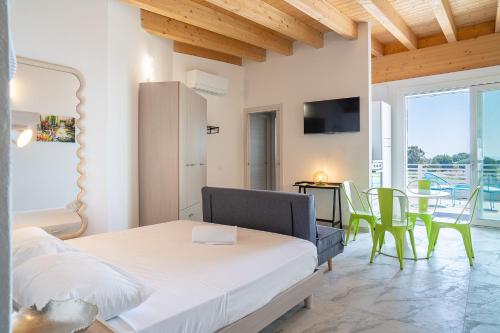 a bedroom with a bed and a table and chairs at Venti del Garda in Montinelle