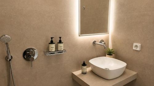 a bathroom with a sink and a mirror at Balis Villa Naxos in Agios Prokopios