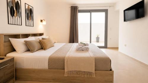 a bedroom with a bed with two stuffed animals on it at Balis Villa Naxos in Agios Prokopios