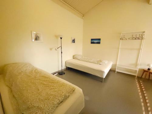 a room with two beds in a room at Kaldbakur Guesthouse in Heimaland