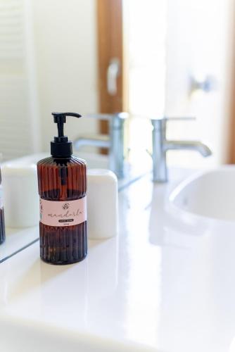a bottle of soap sitting on a bathroom counter at Casa Vacanza 2 Mari in Alghero