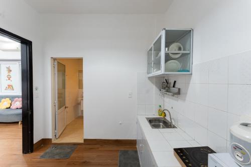 a kitchen with a sink and a counter top at Chic Studio Homestay in Hue