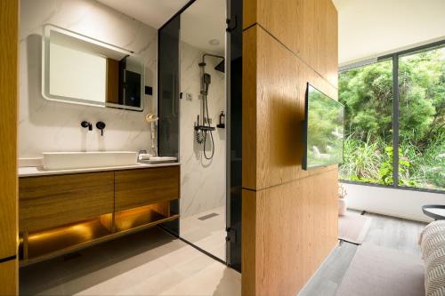 a bathroom with a sink and a mirror at 微云隐舍 in Jiazaiwei