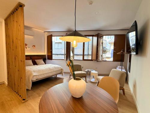 a living room with a bed and a table in a room at YourHouse O Foxo in Allariz