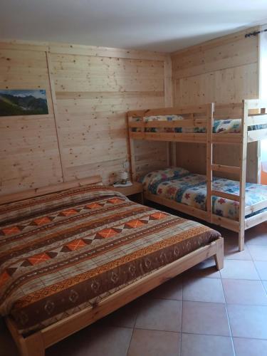 a bedroom with two bunk beds in a cabin at LOCANDA Alla Paia in Pracul