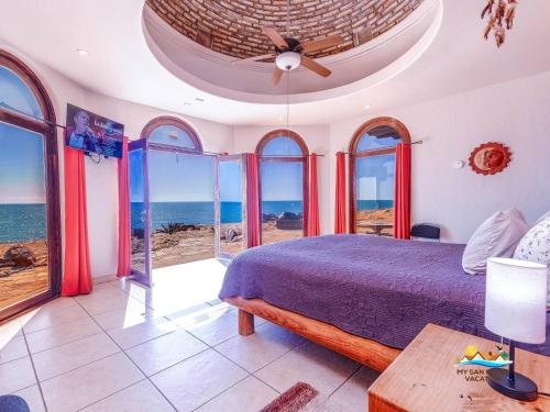 a bedroom with a bed and views of the ocean at Casa Serenity Beachfront Rental in San Felipe