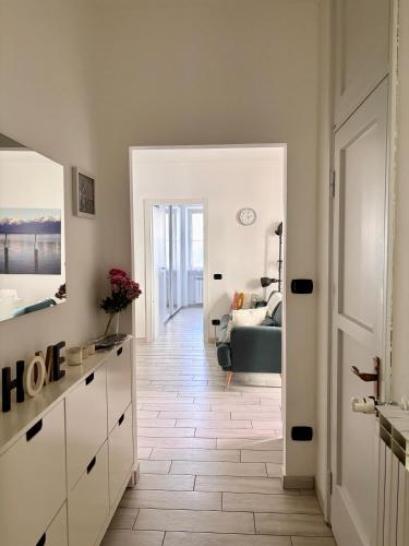 a hallway with a living room with a couch at La Casa Gialla di Valentina in Bellano