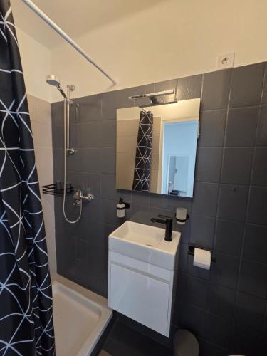 a bathroom with a sink and a mirror and a tub at SOBE ŠOTIĆ in Rab
