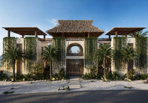 a house with a gate and palm trees in front at Casa Joseph Troncones - Adults Only in Troncones