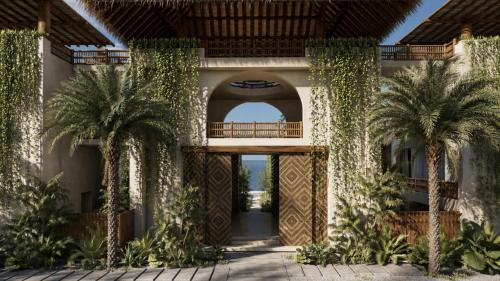 an external view of a house with palm trees at Casa Joseph Troncones - Adults Only in Troncones