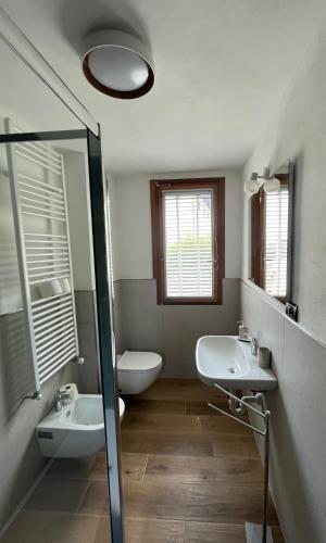 a bathroom with two sinks and a glass shower at Chalet Blanc le Refuge in Courmayeur