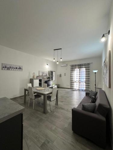 a living room with a couch and a table at Casa Inyco in Menfi