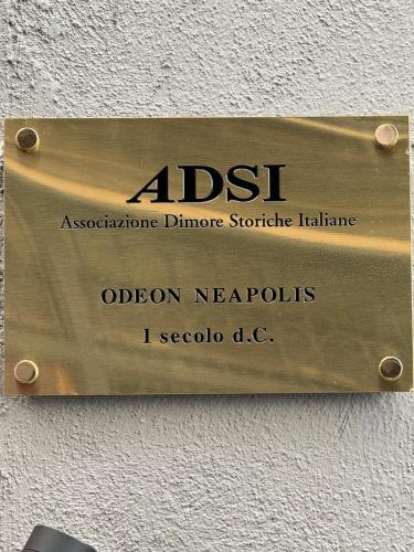 a sign on a wall that reads aost aosotephonephonephone structure at Odeon Neapolis - Historic Suites in Roman Theater in Naples