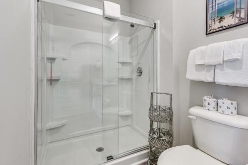a shower stall in a bathroom with a toilet at Golf + Poolside Days! Condo 9 Mi to Sunset Beach in Calabash