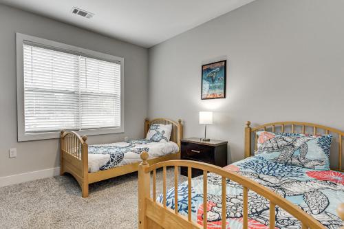 a bedroom with two beds and a window at Golf + Poolside Days! Condo 9 Mi to Sunset Beach in Calabash